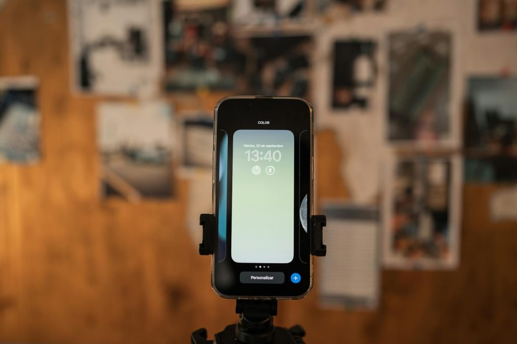Close-up of a smartphone displaying time, captured indoors with a blurred background.
