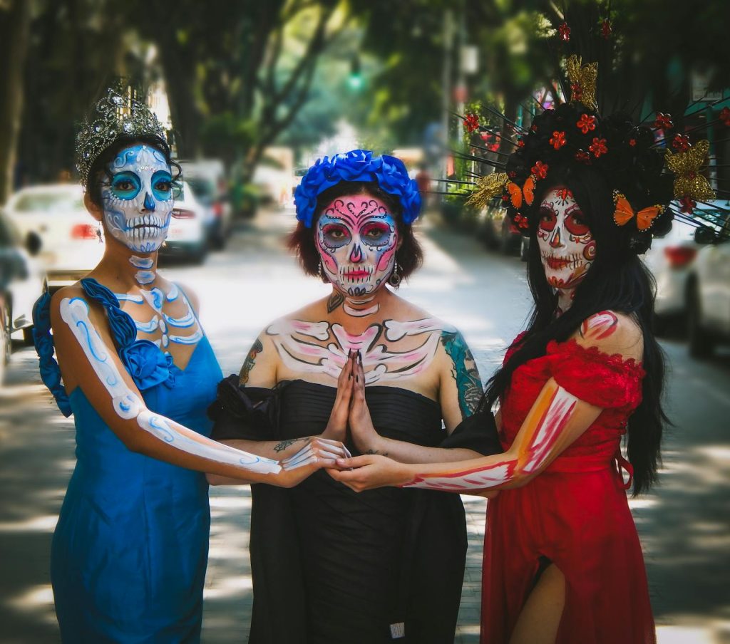 group of women in dresses and makeup for the day of the dead celebrations in mexico